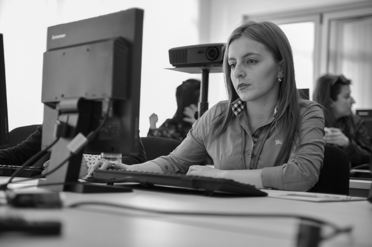 NDI Photo. Woman does work on computer.